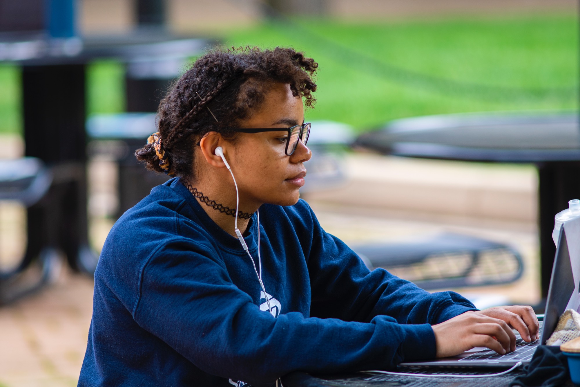 a student listen to music while studying outside